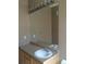Bathroom vanity featuring a large mirror, bright vanity lighting, and a white sink at 1575 Olympia Cir # 208, Castle Rock, CO 80104