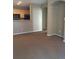 Open-concept living space with a kitchen view, neutral walls, and plush carpeting at 1575 Olympia Cir # 208, Castle Rock, CO 80104