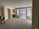 Bright living room featuring a fireplace, neutral walls, and sliding glass doors leading to a balcony at 1575 Olympia Cir # 208, Castle Rock, CO 80104