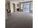 Bright and open living room with a fireplace, sliding doors to the balcony and breakfast bar seating at 1575 Olympia Cir # 208, Castle Rock, CO 80104