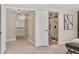 Hallway with light fixtures and a modern bathroom view at 6655 W Glasgow Ave, Littleton, CO 80128