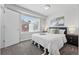 Bright bedroom features a cozy queen bed, soft carpet, and ample natural light from the window at 1064 Depew St, Lakewood, CO 80214