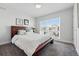Bedroom with modern style, soft carpet, a large window, and a comfortable platform bed at 1064 Depew St, Lakewood, CO 80214