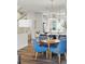 Open dining area features a round table, four chairs, and modern lighting at 1064 Depew St, Lakewood, CO 80214