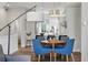 Modern dining area with stylish lighting fixtures, seamlessly connects the living room and kitchen at 1064 Depew St, Lakewood, CO 80214