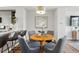 Inviting dining area with a round table, stylish chairs and modern pendant lighting at 1064 Depew St, Lakewood, CO 80214