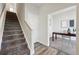 Inviting entryway features carpeted stairs, a glimpse of a bright office, and stylish flooring at 1064 Depew St, Lakewood, CO 80214