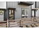Modern townhome entrance featuring a stylish door, house number, and a charming wooden fence at 1064 Depew St, Lakewood, CO 80214