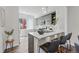 Modern kitchen featuring stainless steel appliances and a breakfast bar with stools at 1064 Depew St, Lakewood, CO 80214