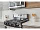 Modern kitchen with stainless steel appliances and stone countertops at 1064 Depew St, Lakewood, CO 80214