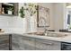 Close up of a stainless steel sink and stone countertops in a modern kitchen at 1064 Depew St, Lakewood, CO 80214
