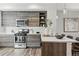 Bright kitchen features stainless steel appliances, stone countertops, and stylish cabinets at 1064 Depew St, Lakewood, CO 80214