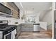 Open concept kitchen features stainless appliances and a view into the staircase at 1064 Depew St, Lakewood, CO 80214
