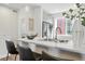 Kitchen with stainless steel appliances, breakfast bar with stools, and open floorplan at 1064 Depew St, Lakewood, CO 80214
