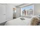 Bright bedroom with white walls, carpet floor and a large window letting in natural light at 1064 Depew St, Lakewood, CO 80214