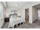 Relaxing bedroom with carpet floors, a white bed, and a sliding door to the bathroom at 1064 Depew St, Lakewood, CO 80214