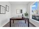 Bright office space features modern artwork, a sleek desk, and a large window at 1064 Depew St, Lakewood, CO 80214