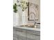 Modern kitchen sink with sleek faucet, complemented by stylish vases and contemporary artwork at 1064 Depew St, Lakewood, CO 80214