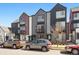 Modern townhomes with unique architectural details and a mix of exterior finishes along the street at 1064 Depew St, Lakewood, CO 80214