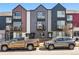 Street view of modern townhomes with unique architectural details and a mix of exterior finishes at 1064 Depew St, Lakewood, CO 80214