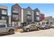 Modern townhomes with unique architectural details and a mix of exterior finishes along the street at 1064 Depew St, Lakewood, CO 80214