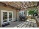 Back deck with a lattice wood awning and outdoor seating at 8258 S Reed Way, Littleton, CO 80128