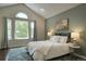 Serene bedroom with vaulted ceilings, plush rug, stylish furnishings, and a large window offering outdoor views at 8258 S Reed Way, Littleton, CO 80128