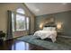Tranquil bedroom with a large window, plush rug, stylish furnishings, and an art piece enhancing the ambiance at 8258 S Reed Way, Littleton, CO 80128