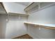 Walk-in closet with hardwood floor and wooden rods for hanging clothes, perfect for organization at 8258 S Reed Way, Littleton, CO 80128