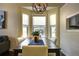 Cozy dining area with large windows, a modern chandelier, and a dining table with seating for four at 8258 S Reed Way, Littleton, CO 80128