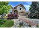 Charming exterior of a two-story home with a well-manicured lawn and stone walkway at 8258 S Reed Way, Littleton, CO 80128