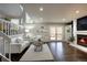 Bright living room featuring comfortable seating, hardwood floors, a cozy fireplace, and access to outdoor deck at 8258 S Reed Way, Littleton, CO 80128