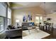 Bright living room with vaulted ceilings, hardwood floors, and stylish modern furniture at 8258 S Reed Way, Littleton, CO 80128