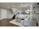 Spacious living room with an open layout, hardwood floors, and comfortable seating with views to the kitchen at 8258 S Reed Way, Littleton, CO 80128