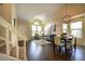 Open concept living area featuring high ceilings, hardwood floors, and a modern dining set at 8258 S Reed Way, Littleton, CO 80128