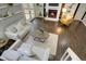 Open living room showcasing modern furnishings, a stylish fireplace, hardwood floors, and access to outdoor deck at 8258 S Reed Way, Littleton, CO 80128