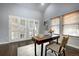 Stylish home office featuring french doors, a desk and a modern chair at 8258 S Reed Way, Littleton, CO 80128