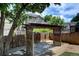 Backyard wooden pergola with a lattice roof and pea gravel ground cover at 8258 S Reed Way, Littleton, CO 80128