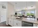 Modern kitchen with granite countertops, stainless steel appliances, and an open view to the fireplace at 2500 E Cherry Creek South Dr # 313, Denver, CO 80209