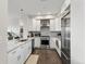Modern kitchen boasts stainless steel appliances, white cabinetry, granite countertops, and an open layout for seamless entertaining at 2500 E Cherry Creek South Dr # 313, Denver, CO 80209