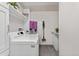 Bright laundry room with a washer, dryer, and additional storage cabinets at 2500 E Cherry Creek South Dr # 313, Denver, CO 80209
