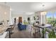 Open concept living room with fireplace, dining area, bar seating, and hardwood floors at 2500 E Cherry Creek South Dr # 313, Denver, CO 80209