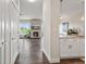 Open-concept space with hardwood floors flowing into a kitchen area, a living room with fireplace, and bright windows at 2500 E Cherry Creek South Dr # 313, Denver, CO 80209