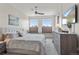 Serene main bedroom with large windows, dresser, and ceiling fan at 2500 E Cherry Creek South Dr # 313, Denver, CO 80209