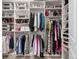 A walk-in closet with shelving and storage for shoes, purses, and folded garments at 2500 E Cherry Creek South Dr # 313, Denver, CO 80209