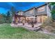 Expansive backyard featuring a patio with a fireplace, grill, dining and lounge seating for ultimate outdoor enjoyment at 10459 Rivington Ct, Lone Tree, CO 80124