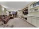 Cozy finished basement with built-in shelving, a wet bar, and comfortable seating area perfect for entertaining at 10459 Rivington Ct, Lone Tree, CO 80124