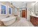 Luxurious bathroom with a soaking tub, a separate glass shower, and stylish tile flooring at 10459 Rivington Ct, Lone Tree, CO 80124