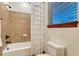Cozy bathroom featuring white shower curtain, window with blinds, and a toilet at 10459 Rivington Ct, Lone Tree, CO 80124