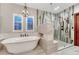 Beautiful bathroom with a soaking tub, a separate glass shower, and stylish tile flooring at 10459 Rivington Ct, Lone Tree, CO 80124